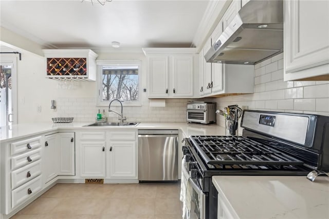 kitchen featuring extractor fan, appliances with stainless steel finishes, sink, and white cabinets