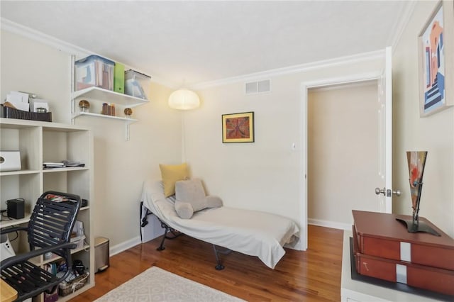 sitting room featuring crown molding and hardwood / wood-style flooring