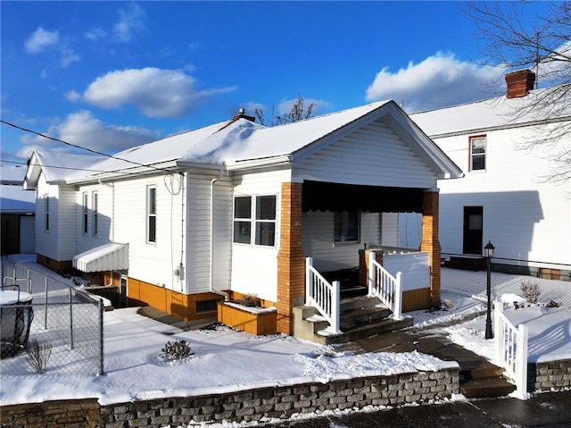 view of snow covered back of property