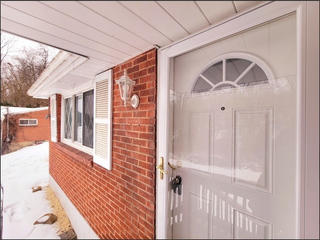 view of snow covered property entrance