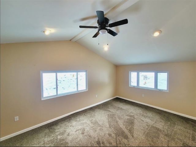 carpeted spare room with plenty of natural light and vaulted ceiling with beams