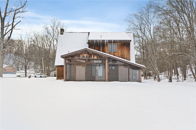 view of snow covered rear of property