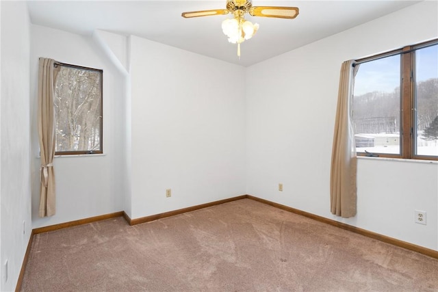 unfurnished room with ceiling fan and carpet