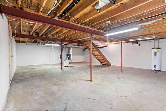 basement featuring heating unit and electric water heater