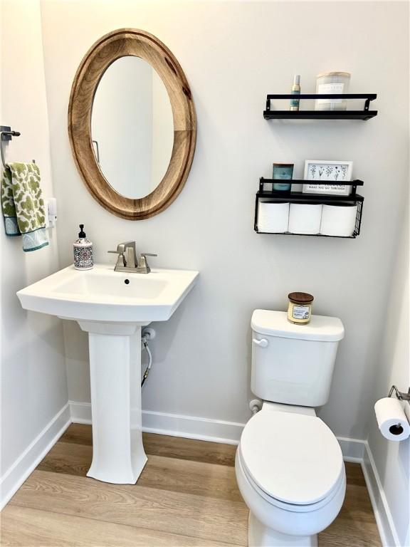 bathroom featuring hardwood / wood-style flooring and toilet