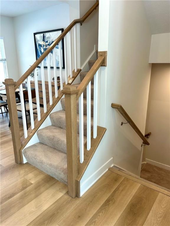 stairs with wood-type flooring