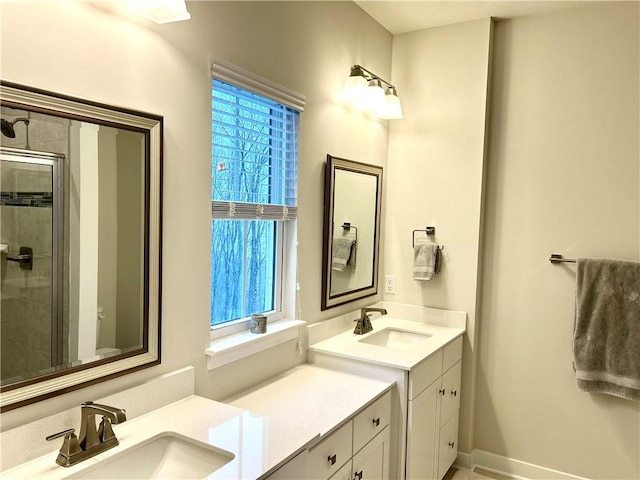 bathroom with vanity, a healthy amount of sunlight, and walk in shower