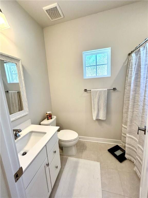 bathroom featuring tile patterned flooring, vanity, a shower with curtain, and toilet