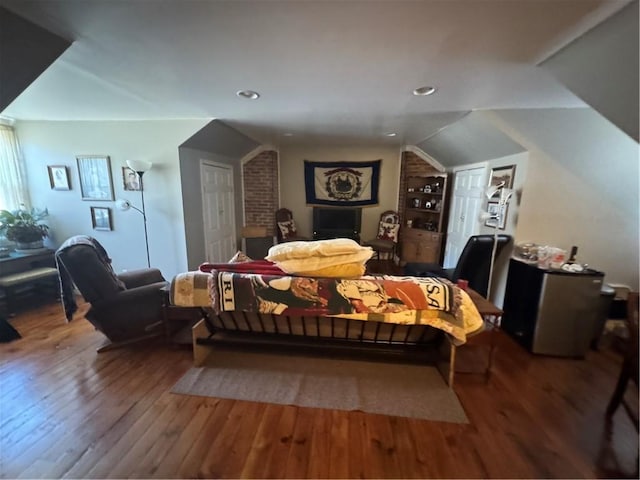 bedroom featuring vaulted ceiling and hardwood / wood-style floors