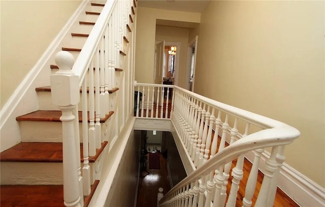 staircase with wood-type flooring