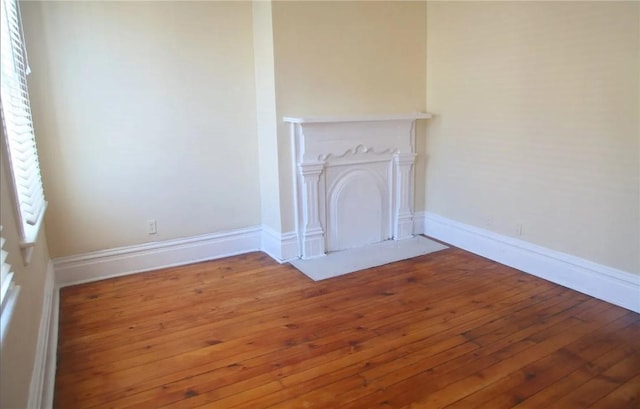 unfurnished living room with hardwood / wood-style flooring