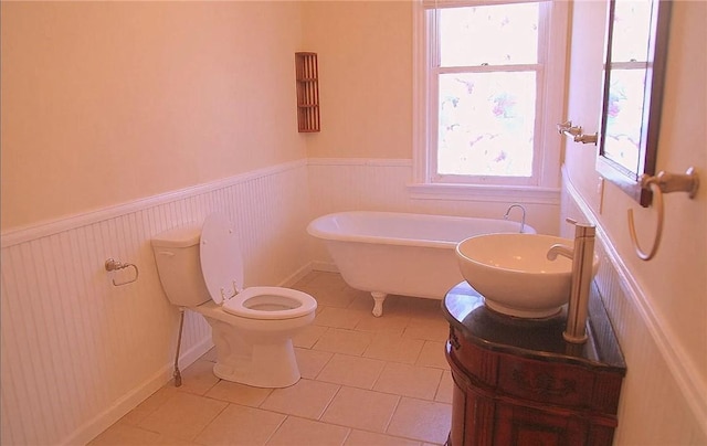 bathroom with vanity, a washtub, tile patterned flooring, and toilet