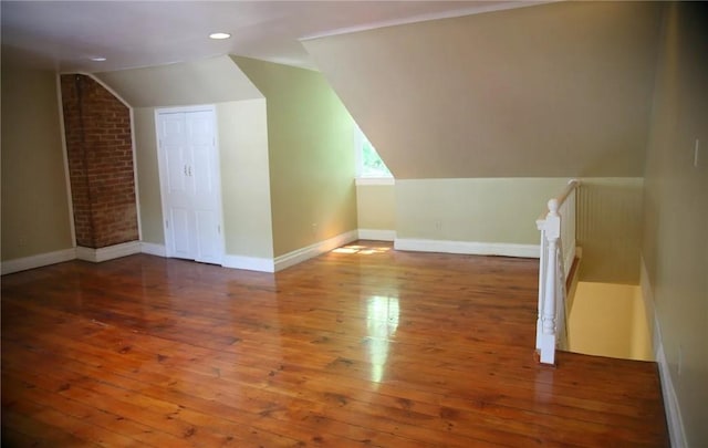 additional living space featuring dark hardwood / wood-style floors and vaulted ceiling