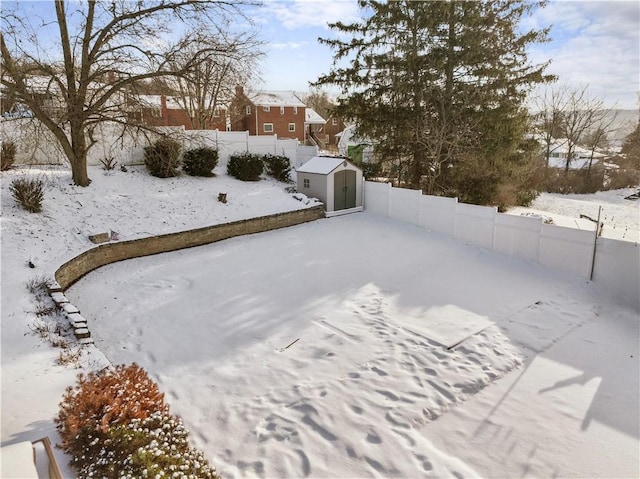 snowy yard with a storage unit