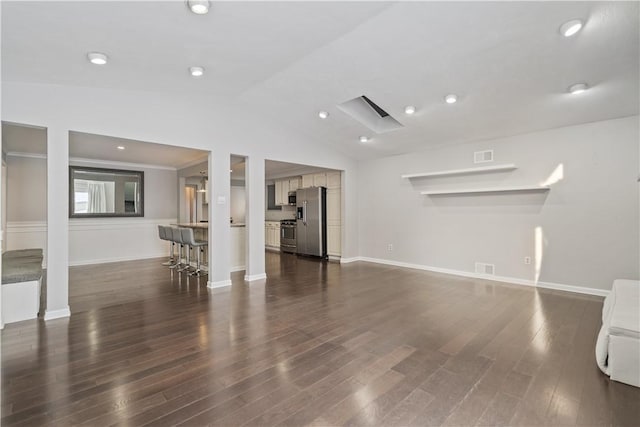 unfurnished living room featuring vaulted ceiling and dark wood-type flooring