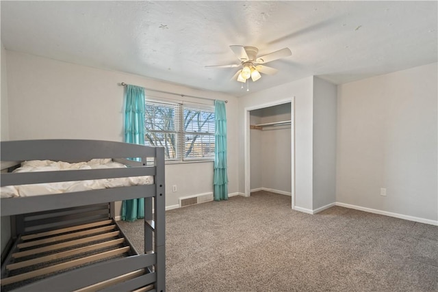 carpeted bedroom with ceiling fan and a closet