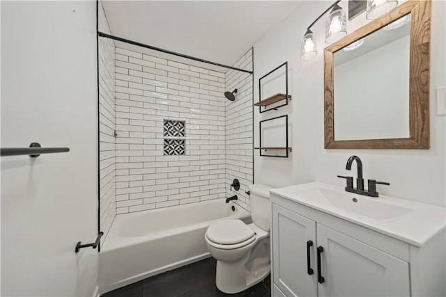 full bathroom with tiled shower / bath, vanity, and toilet