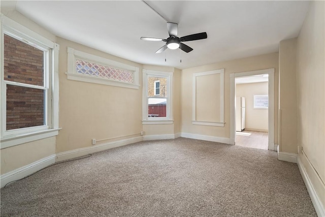 carpeted empty room featuring ceiling fan