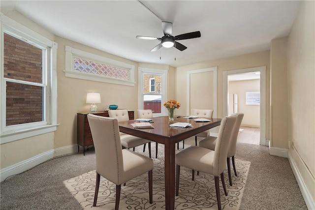 dining room with light carpet and ceiling fan