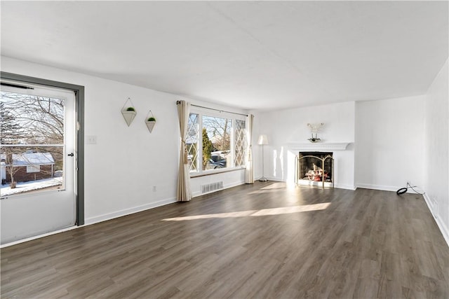 unfurnished living room featuring dark wood-type flooring