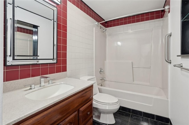 full bathroom with tile patterned floors, tile walls, toilet, shower / tub combination, and vanity