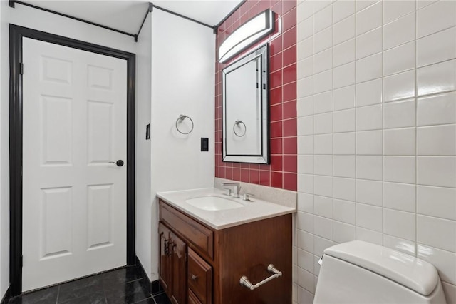 bathroom featuring toilet, tile walls, tile patterned floors, and vanity