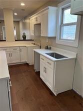 kitchen with white cabinetry and dark hardwood / wood-style flooring