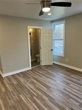 unfurnished bedroom featuring dark hardwood / wood-style floors and ceiling fan