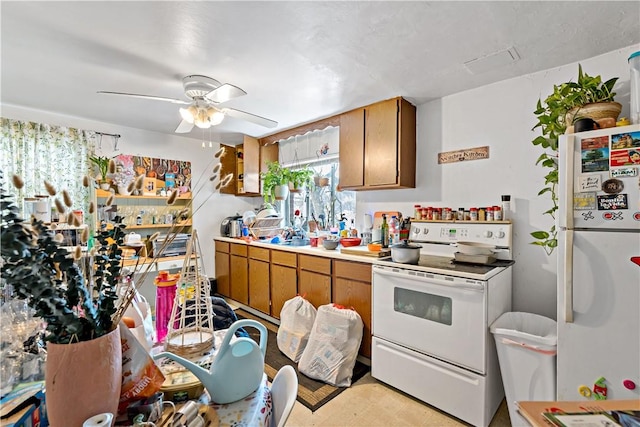 kitchen featuring ceiling fan and white appliances