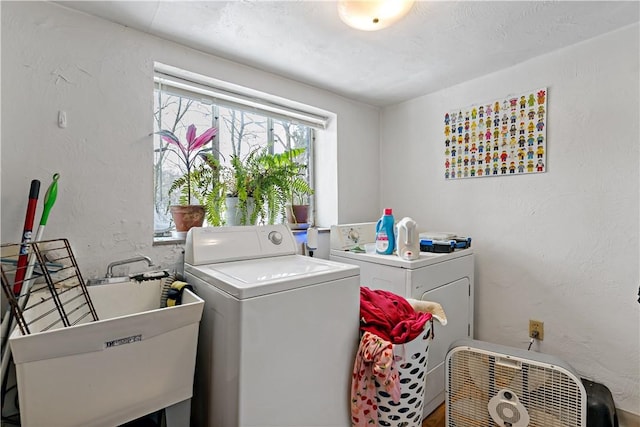 laundry room featuring sink and separate washer and dryer