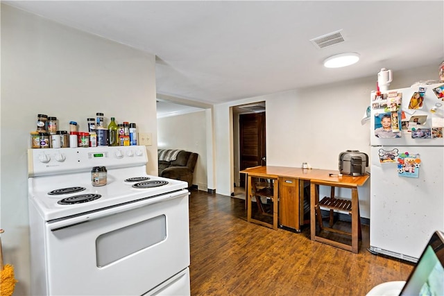 kitchen with white appliances and dark hardwood / wood-style flooring