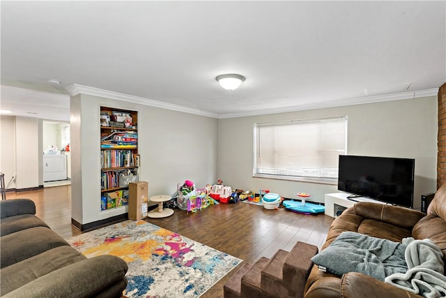 living room featuring hardwood / wood-style flooring, ornamental molding, and washer / clothes dryer