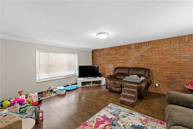 living room with brick wall, crown molding, and dark hardwood / wood-style floors