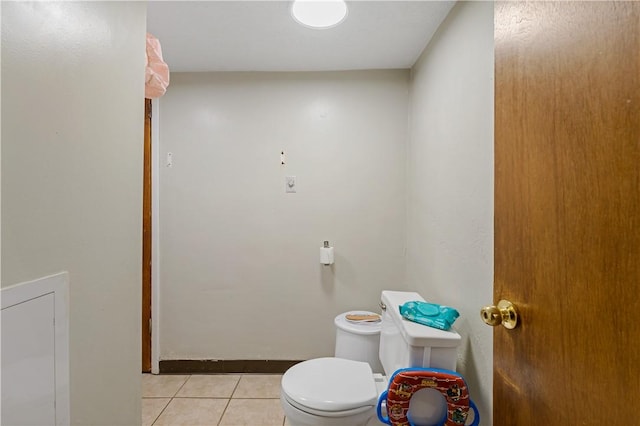 bathroom featuring toilet and tile patterned flooring