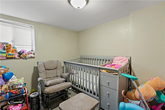 bedroom featuring a nursery area