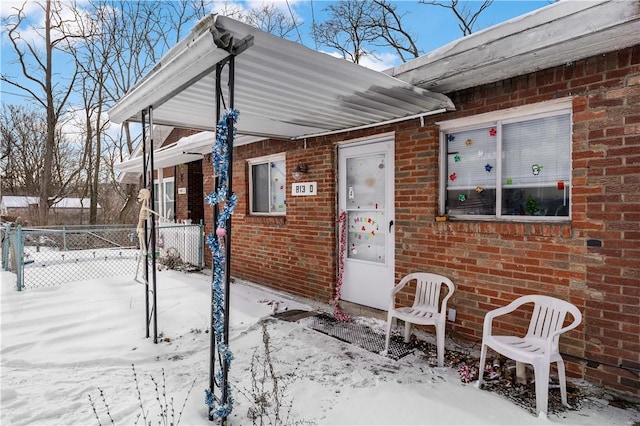 view of snow covered property entrance