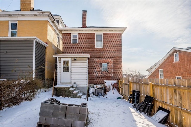 view of snow covered rear of property