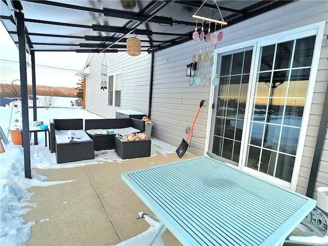 snow covered patio featuring outdoor lounge area and a pergola