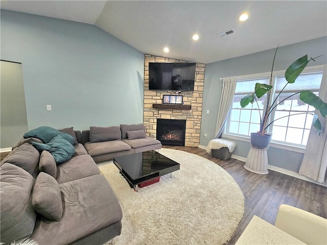 living room featuring dark hardwood / wood-style floors, a fireplace, and lofted ceiling