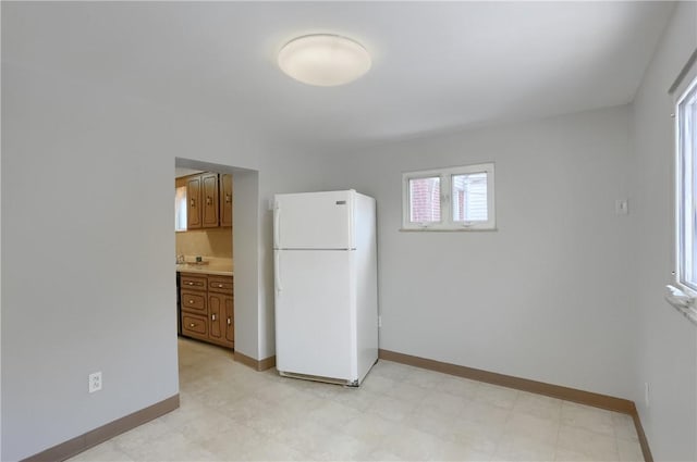 kitchen featuring decorative backsplash and white fridge