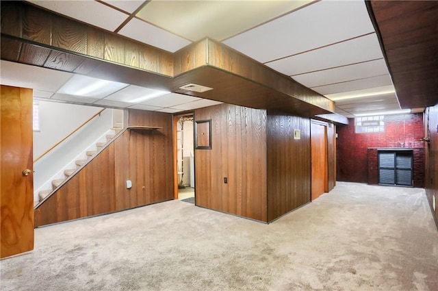 interior space with light carpet and wood walls