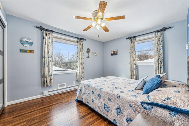 bedroom featuring ceiling fan, a baseboard radiator, and dark hardwood / wood-style flooring