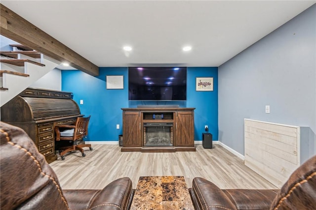 living room with light wood-type flooring and beam ceiling