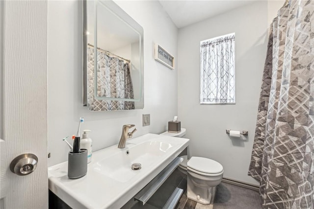 bathroom with toilet, vanity, and a shower with curtain