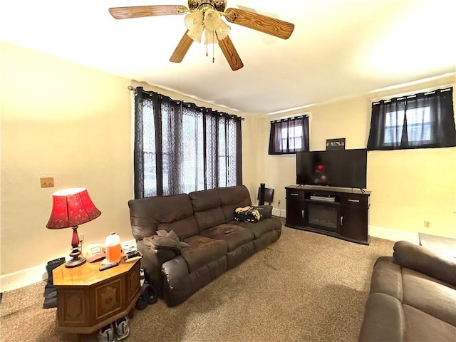 carpeted living room featuring ceiling fan