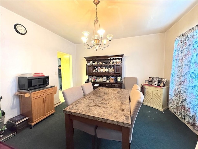 carpeted dining room featuring an inviting chandelier