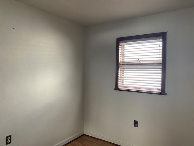 spare room with dark hardwood / wood-style floors