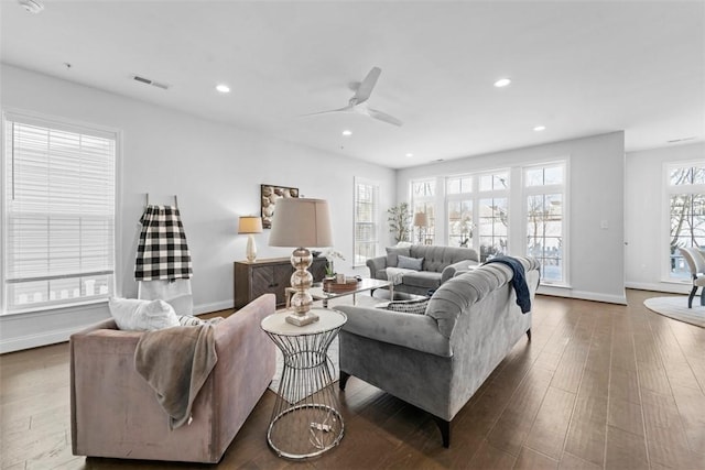 living room with hardwood / wood-style flooring, ceiling fan, and a wealth of natural light