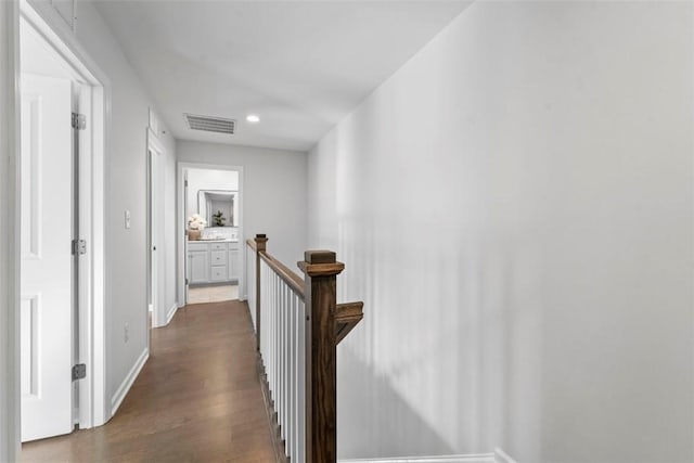 hallway with dark hardwood / wood-style flooring