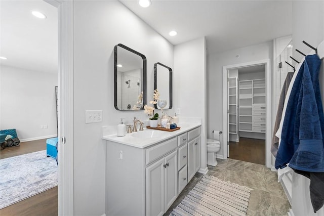 bathroom featuring hardwood / wood-style flooring, vanity, and toilet